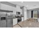 Bright kitchen showcasing stainless steel appliances, granite countertops, and ample cabinet space at 3192 Timorasso Ave, Henderson, NV 89044