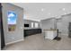 Spacious room featuring an open-concept layout, a gray sectional sofa, and modern kitchen at 3192 Timorasso Ave, Henderson, NV 89044