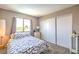 Inviting bedroom featuring a patterned bedspread, natural light, and closet for storage at 361 Tobler Dr, Las Vegas, NV 89145