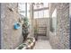 Charming courtyard featuring a stone fountain, brick flooring, decorative pots, and stucco walls at 361 Tobler Dr, Las Vegas, NV 89145