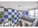 Open hallway boasts a modern, checkerboard accent wall and iron railing overlooking the entryway below at 361 Tobler Dr, Las Vegas, NV 89145