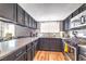 Stylish kitchen with stainless steel appliances, dark cabinetry and countertops, and modern finishes at 361 Tobler Dr, Las Vegas, NV 89145