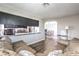 Open-concept living space showcasing a comfortable sectional, wood flooring, and flow to dining room at 361 Tobler Dr, Las Vegas, NV 89145