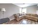 Comfortable living room featuring a large sectional sofa and wood-look flooring for relaxation at 361 Tobler Dr, Las Vegas, NV 89145
