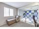 Cozy loft area with neutral carpet, a window, and comfortable seating overlooking the statement wall below at 361 Tobler Dr, Las Vegas, NV 89145