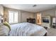 Bright primary bedroom showcasing a large bed, dresser and view into the primary bathroom at 361 Tobler Dr, Las Vegas, NV 89145