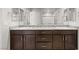 Elegant bathroom featuring dual sinks, granite countertops, and ample storage at 382 Scarlet Pine Ct, Henderson, NV 89044