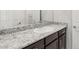 Bathroom vanity with dark wood cabinets, granite counters, and white basin sink at 382 Scarlet Pine Ct, Henderson, NV 89044