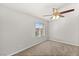 Bright bedroom features a ceiling fan, neutral carpet, and a window with views at 382 Scarlet Pine Ct, Henderson, NV 89044