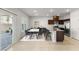 Open-concept dining area with a stylish table set, adjacent to a modern kitchen with stainless steel appliances at 382 Scarlet Pine Ct, Henderson, NV 89044
