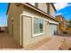 Home exterior with paved driveway, rock landscaping, and privacy gate at 382 Scarlet Pine Ct, Henderson, NV 89044