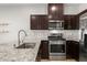 A kitchen view featuring stainless steel appliances and stone countertops at 382 Scarlet Pine Ct, Henderson, NV 89044