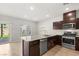 Well-lit kitchen with modern stainless steel appliances and stone countertops at 382 Scarlet Pine Ct, Henderson, NV 89044