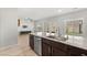 Modern kitchen sink and stone countertops with view into the living room at 382 Scarlet Pine Ct, Henderson, NV 89044