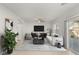 Spacious living room featuring contemporary furnishings, a large TV, and sliding door access to outdoor space at 382 Scarlet Pine Ct, Henderson, NV 89044