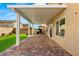 Spacious covered patio area with brick pavers and well-maintained artificial grass at 382 Scarlet Pine Ct, Henderson, NV 89044