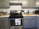 Well-lit kitchen with a stainless steel oven, light countertops, and grey cabinets at 432 Sellers Pl, Henderson, NV 89011