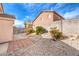Backyard featuring desert landscaping, stone pavers, and cinder block perimeter walls at 4381 Coyote Crest Ct, Las Vegas, NV 89147