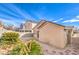 View of the backyard featuring desert landscaping, stone pavers, and cinder block perimeter walls at 4381 Coyote Crest Ct, Las Vegas, NV 89147