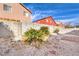 Backyard featuring desert landscaping, stone pavers, and cinder block perimeter walls at 4381 Coyote Crest Ct, Las Vegas, NV 89147