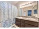 Bathroom featuring a double vanity and shower with decorative curtain at 4381 Coyote Crest Ct, Las Vegas, NV 89147
