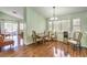 Dining area with wood floors, a chandelier, and a view of the living room and outdoor patio at 4381 Coyote Crest Ct, Las Vegas, NV 89147