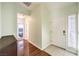 Bright entryway with wood floors, leading to a bedroom with blue accents and a white front door at 4381 Coyote Crest Ct, Las Vegas, NV 89147