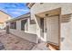 Beige single-story home with stone landscaping and a well-lit front entrance, under a clear blue sky at 4381 Coyote Crest Ct, Las Vegas, NV 89147