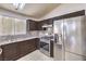 Well-lit kitchen with stainless steel appliances and tiled floor at 4381 Coyote Crest Ct, Las Vegas, NV 89147