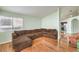 Spacious living room featuring wood floors, a sectional sofa, and an archway leading to other areas at 4381 Coyote Crest Ct, Las Vegas, NV 89147