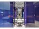 Bathroom features mirrored walls, blue walls, tile floors, vanity, and accent lighting at 4381 W Flamingo Rd # 9301, Las Vegas, NV 89103