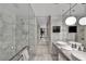 Luxurious bathroom featuring marble walls, a glass-enclosed shower, and dual vessel sinks at 4381 W Flamingo Rd # 9301, Las Vegas, NV 89103