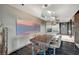 Stylish kitchen with stainless steel island, wood table seating, and contemporary pendant lighting at 4381 W Flamingo Rd # 9301, Las Vegas, NV 89103