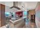Contemporary kitchen with island, bar seating, and floor-to-ceiling windows with city views at 4381 W Flamingo Rd # 9301, Las Vegas, NV 89103