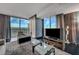 Modern living room with expansive windows offering city views, accented with neutral decor at 4381 W Flamingo Rd # 9301, Las Vegas, NV 89103