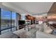 Open-concept living room offering a fireplace, expansive windows, and modern furnishings at 4381 W Flamingo Rd # 9301, Las Vegas, NV 89103