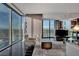 Living room with large windows, comfortable seating, and a view of the cityscape at 4381 W Flamingo Rd # 9301, Las Vegas, NV 89103