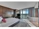 Bright, spacious main bedroom with wood accent wall, a soaking tub, and access to a private balcony at 4381 W Flamingo Rd # 9301, Las Vegas, NV 89103
