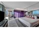 Spacious main bedroom with a king bed, private bath, balcony access, and stunning city views at 4381 W Flamingo Rd # 9301, Las Vegas, NV 89103