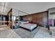 Stylish main bedroom showcasing a plush bed, mirrored accents, wood wall, and marble floors at 4381 W Flamingo Rd # 9301, Las Vegas, NV 89103