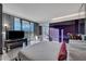 A main bedroom features a cozy bed, balcony access, a large tub and amazing city views at 4381 W Flamingo Rd # 9301, Las Vegas, NV 89103