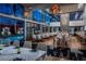 An elegant dining room has soaring ceilings, unique lighting, a fireplace, and pool views at 4381 W Flamingo Rd # 9301, Las Vegas, NV 89103