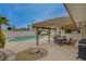 Backyard oasis with covered patio, built-in grill, inground pool, and plenty of seating at 4678 San Benito St, Las Vegas, NV 89121