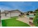 An impressive backyard with artificial turf, pavers, pool, fire pit, and exterior space at 4678 San Benito St, Las Vegas, NV 89121