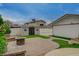 Private backyard featuring decorative stonework, synthetic grass, and additional storage at 4678 San Benito St, Las Vegas, NV 89121