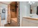 This bathroom features an updated shower with decorative tile and wood trim vanity at 4678 San Benito St, Las Vegas, NV 89121