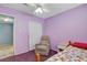 Purple bedroom with a recliner chair and double closet at 4678 San Benito St, Las Vegas, NV 89121