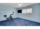 Blue bedroom with exercise bike and window at 4678 San Benito St, Las Vegas, NV 89121