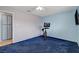 Bedroom with blue walls, exercise bike and tv at 4678 San Benito St, Las Vegas, NV 89121