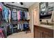 Walk-in closet with custom shelving and ample storage sits next to a vanity at 4678 San Benito St, Las Vegas, NV 89121